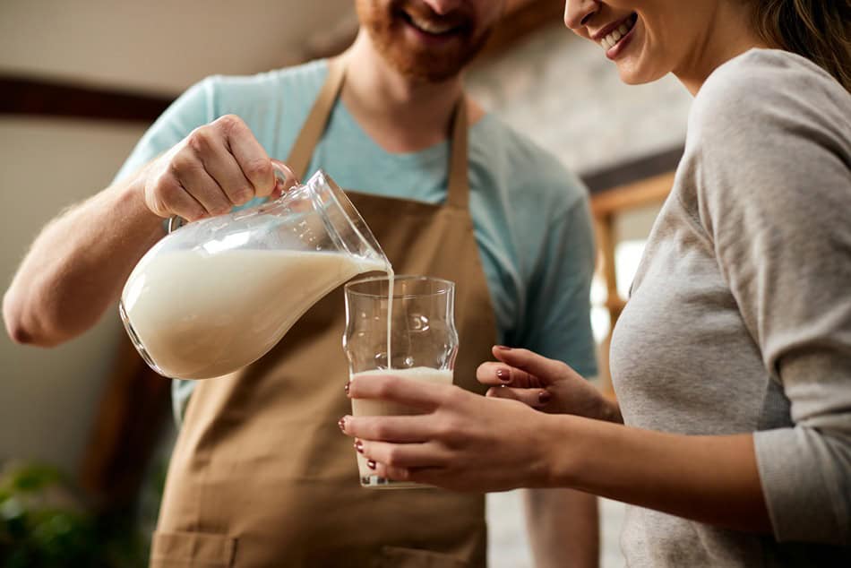 close up of man pouring milk into girlfriend s gla 2024 12 13 17 07 49 utc