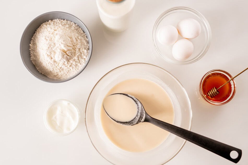 overview of glass bowls with eggs honey dough fo 2025 03 13 07 59 58 utc