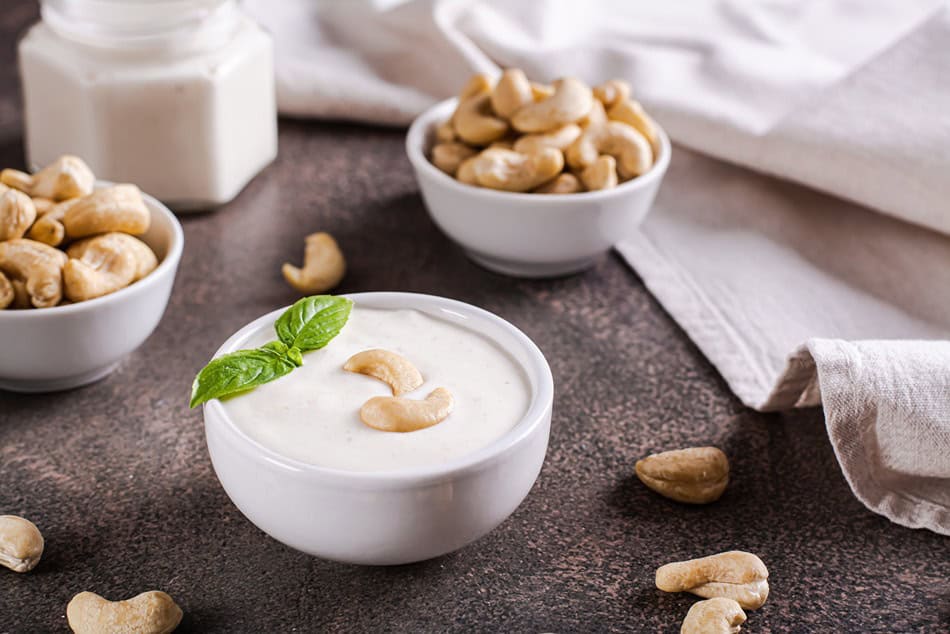 vegan cashew sauce in bowl with basil on table for 2025 02 12 23 03 25 utc